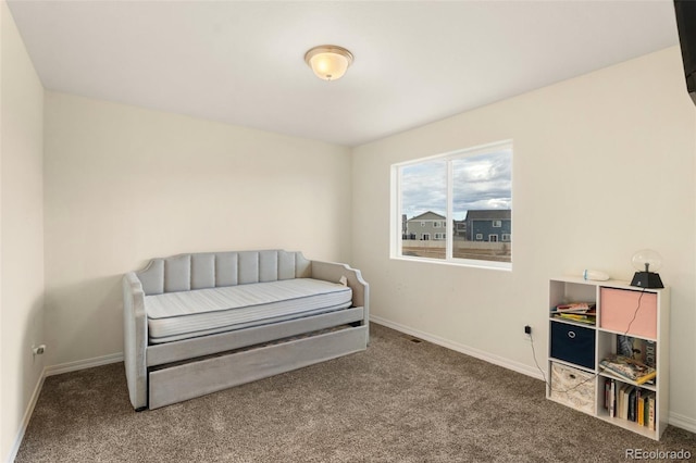 bedroom with carpet floors and baseboards