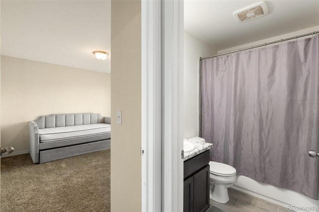 bathroom with visible vents, vanity, toilet, and shower / bath combo with shower curtain