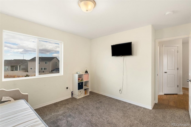 carpeted bedroom with baseboards