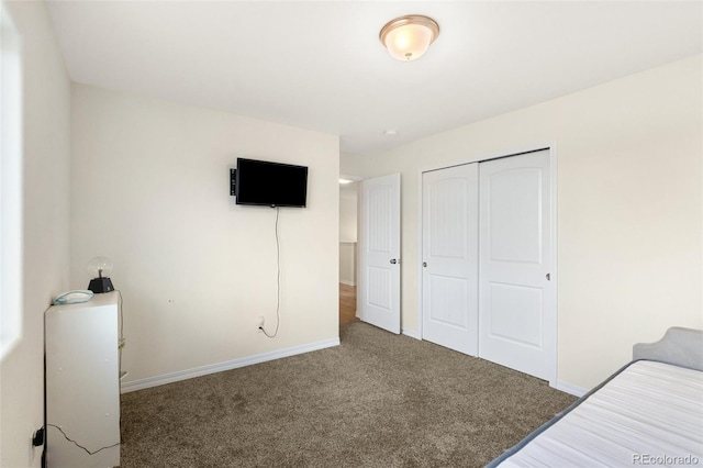 unfurnished bedroom featuring carpet, a closet, and baseboards