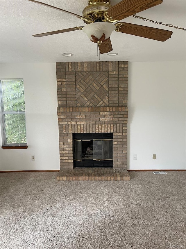 4812 S Bahama Way, Aurora, CO 80015 - unfurnished living room featuring carpet, ceiling fan, a brick fireplace, and baseboards