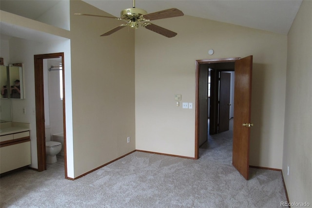 4812 S Bahama Way, Aurora, CO 80015 - unfurnished bedroom with light colored carpet, vaulted ceiling, baseboards, ensuite bath, and a ceiling fan