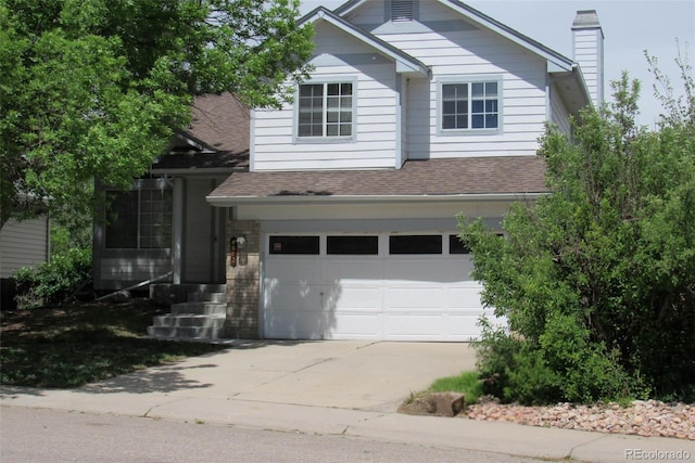 4812 S Bahama Way, Aurora, CO 80015 - traditional-style home with a garage, concrete driveway, roof with shingles, and a chimney