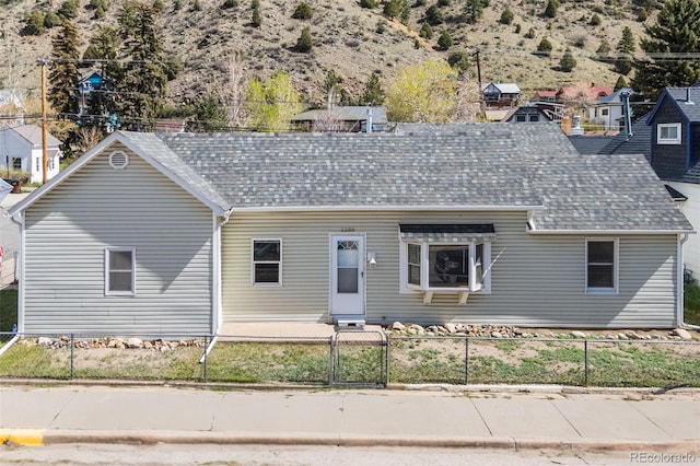 1104 Miner St, Idaho Springs, CO 80452 - view of front facade with a fenced front yard, roof with shingles, and a gate