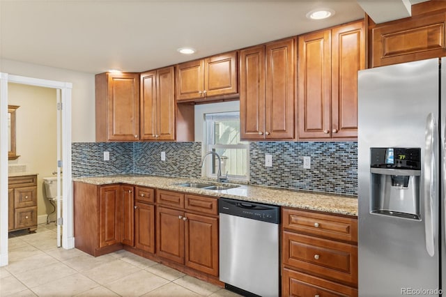 1104 Miner St, Idaho Springs, CO 80452 - kitchen featuring appliances with stainless steel finishes, a sink, light tile patterned floors, backsplash, and light stone countertops