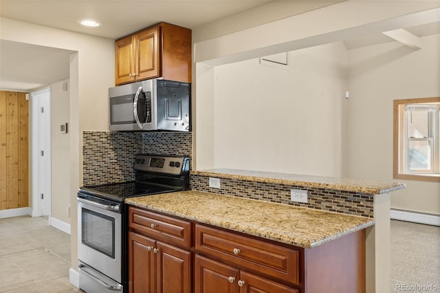 1104 Miner St, Idaho Springs, CO 80452 - kitchen with appliances with stainless steel finishes, baseboards, light stone counters, decorative backsplash, and a peninsula