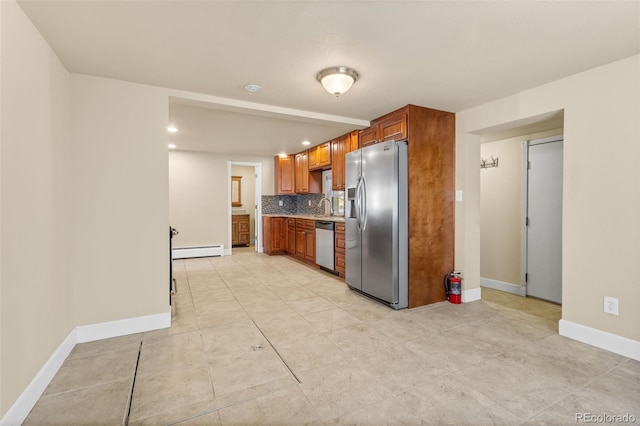 1104 Miner St, Idaho Springs, CO 80452 - kitchen featuring appliances with stainless steel finishes, baseboard heating, baseboards, light countertops, and backsplash