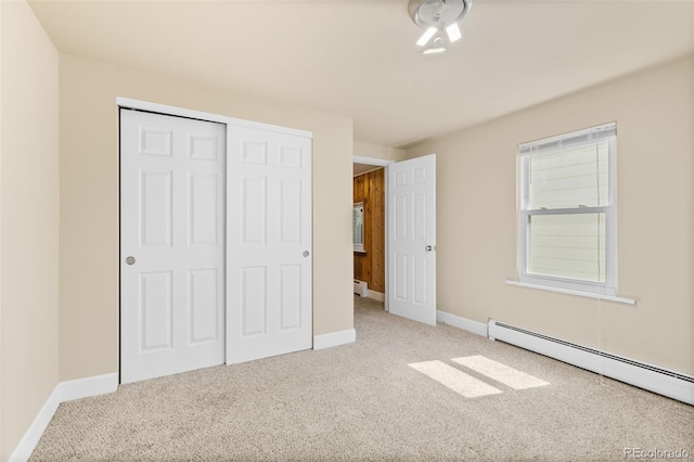 1104 Miner St, Idaho Springs, CO 80452 - unfurnished bedroom featuring a baseboard radiator, carpet flooring, a closet, and baseboards