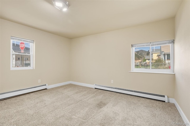1104 Miner St, Idaho Springs, CO 80452 - carpeted empty room featuring a baseboard heating unit, baseboards, and healthy amount of natural light