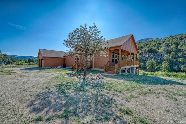 11398 County Road 302, Buena Vista, CO 81211 - view of front facade with an outdoor structure, a front yard, and stairs