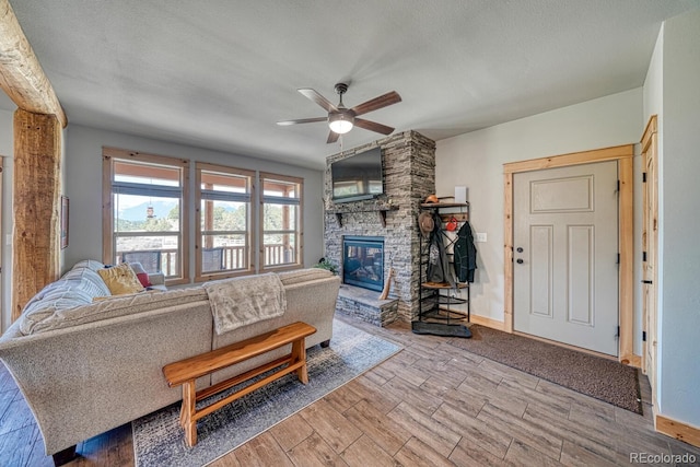 11398 County Road 302, Buena Vista, CO 81211 - living room featuring a ceiling fan, wood finished floors, and a fireplace