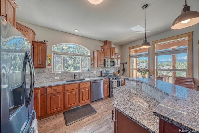 11398 County Road 302, Buena Vista, CO 81211 - kitchen with appliances with stainless steel finishes, brown cabinetry, backsplash, stone countertops, and recessed lighting