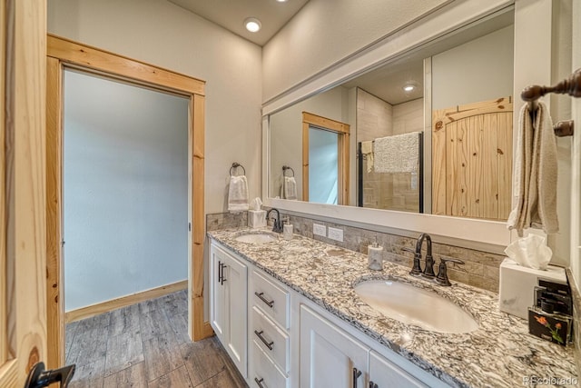 11398 County Road 302, Buena Vista, CO 81211 - bathroom with double vanity, wood finished floors, and a tile shower