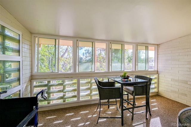 sunroom / solarium with vaulted ceiling and a healthy amount of sunlight