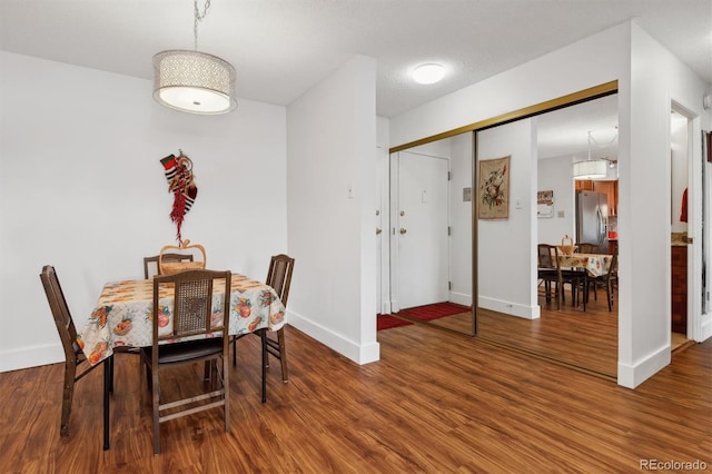 dining area featuring baseboards and wood finished floors
