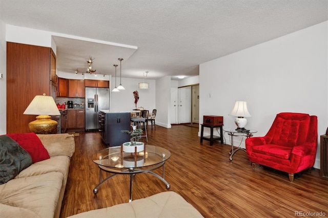 living room featuring dark wood finished floors and a textured ceiling
