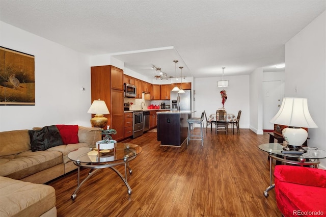 living room featuring a textured ceiling and dark hardwood / wood-style flooring