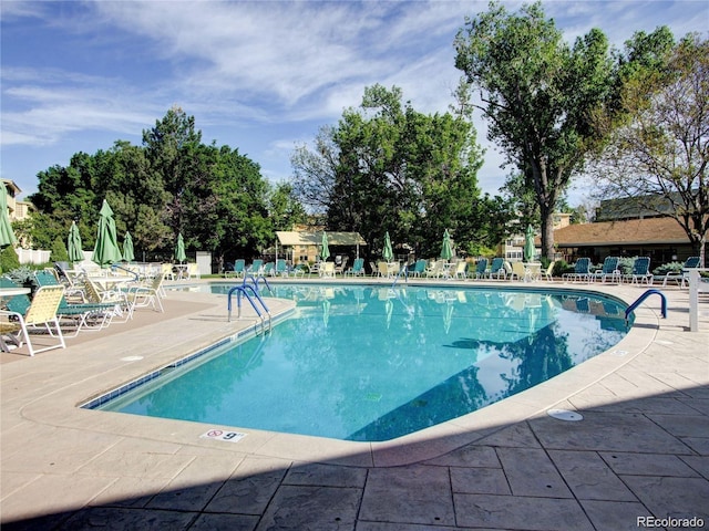 pool featuring fence and a patio