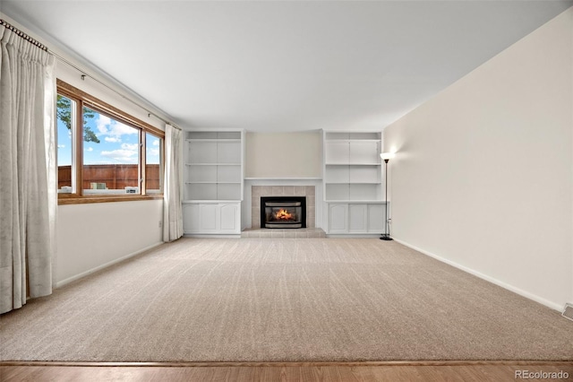 7483 W Cedar Cir, Lakewood, CO 80226 - unfurnished living room with baseboards, carpet floors, and a tiled fireplace