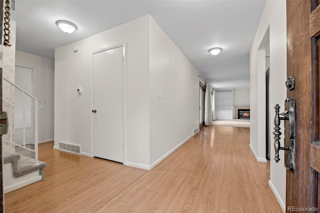 7483 W Cedar Cir, Lakewood, CO 80226 - corridor featuring light wood-style flooring, stairs, and baseboards