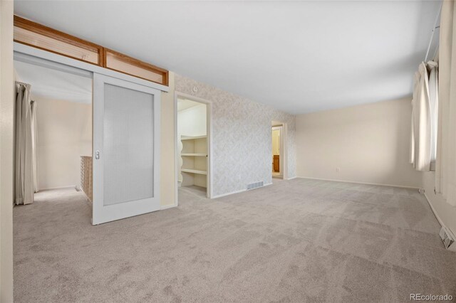 7483 W Cedar Cir, Lakewood, CO 80226 - carpeted empty room with baseboards and wallpapered walls