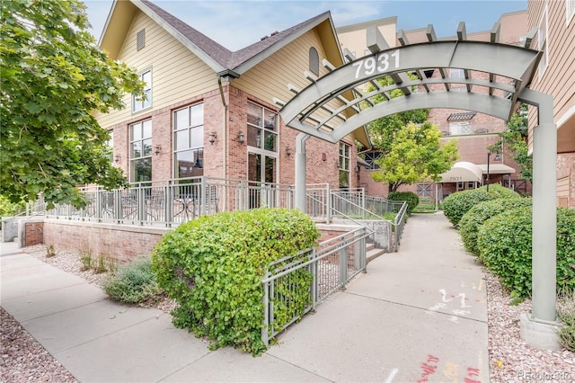 view of home's exterior with fence and brick siding