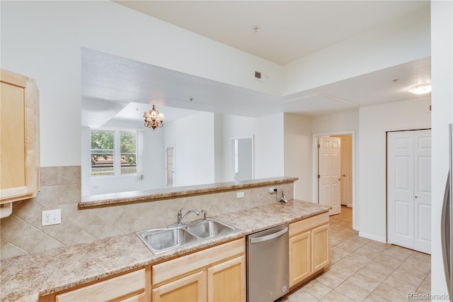 kitchen with visible vents, light countertops, light brown cabinetry, stainless steel dishwasher, and a sink