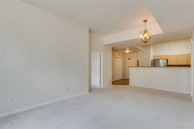 unfurnished living room featuring visible vents, baseboards, a notable chandelier, and light colored carpet