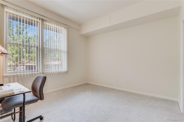 carpeted home office with baseboards