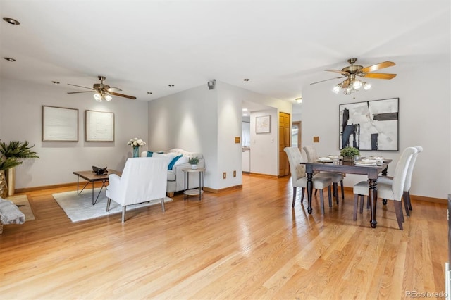 dining space with light wood-type flooring, baseboards, and ceiling fan