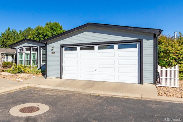 view of front of home featuring a garage and an outdoor structure