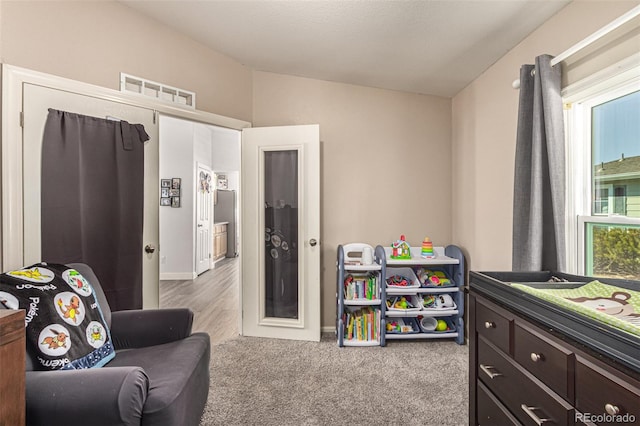 game room with lofted ceiling and light colored carpet