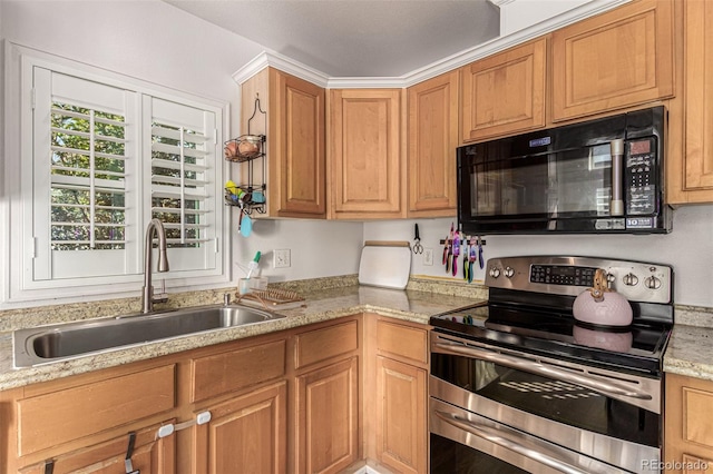 kitchen featuring stainless steel range with electric cooktop, light stone counters, and sink