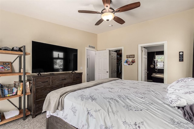 bedroom with carpet floors, ceiling fan, a spacious closet, a closet, and connected bathroom