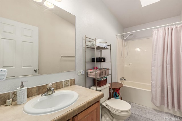 full bathroom with lofted ceiling, vanity, tile patterned floors, shower / bath combo, and toilet