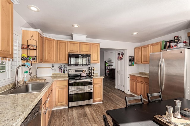 kitchen featuring light stone countertops, sink, dark wood-type flooring, and black appliances