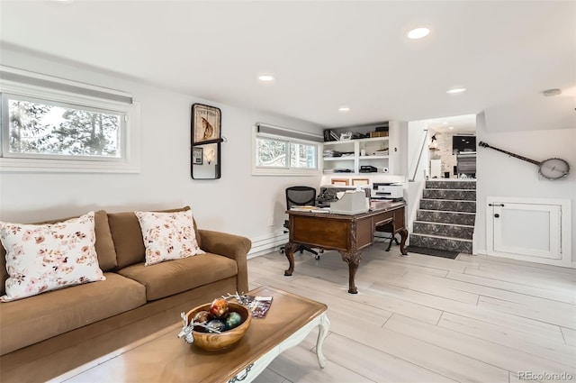 home office featuring light wood-type flooring, a baseboard heating unit, and recessed lighting