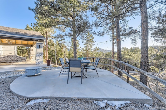 view of patio featuring outdoor dining area and a mountain view
