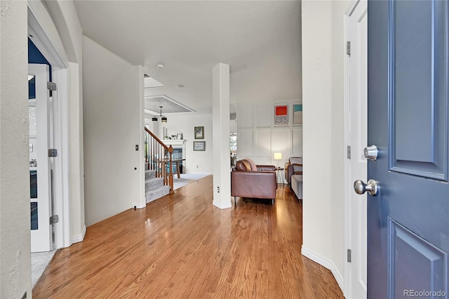 foyer with wood finished floors and stairway