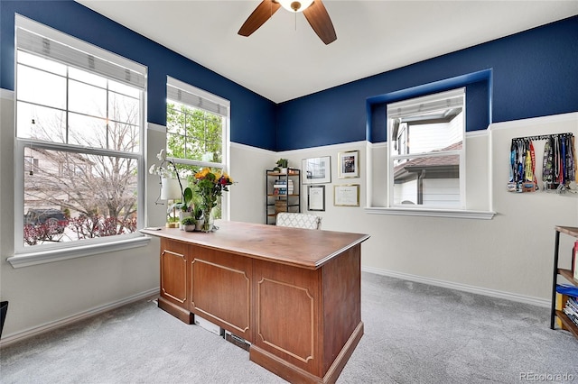 office with a ceiling fan, baseboards, and light carpet