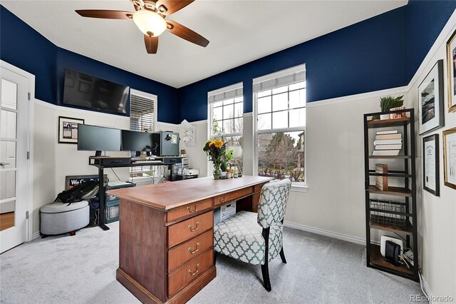 office area with ceiling fan, light colored carpet, and a healthy amount of sunlight