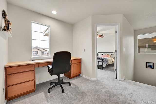 office featuring baseboards and light colored carpet