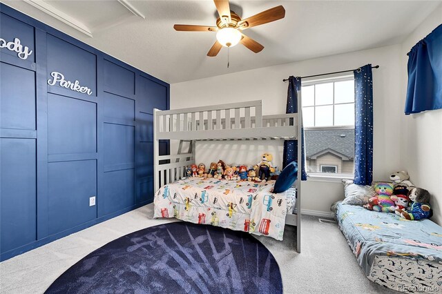 carpeted bedroom with ceiling fan, visible vents, and baseboards