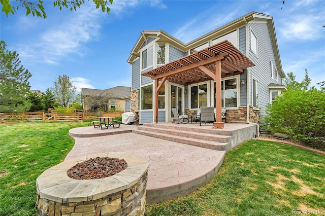 back of property featuring a patio, fence, a yard, a pergola, and stone siding