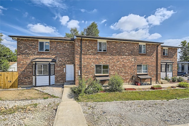 3401 W Milan Ave, Denver, CO 80236 - view of front of house with brick siding, a patio area, and fence