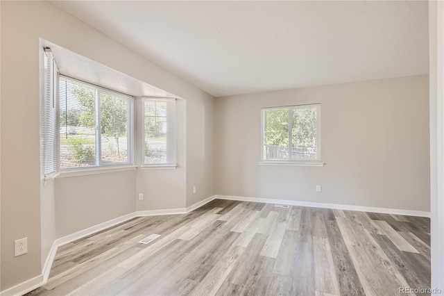 3401 W Milan Ave, Denver, CO 80236 - spare room with plenty of natural light, light wood-style flooring, and baseboards
