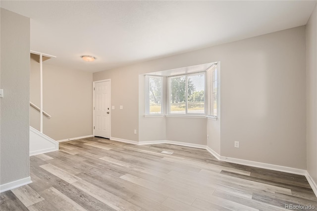 3401 W Milan Ave, Denver, CO 80236 - unfurnished living room featuring light wood-style flooring and baseboards