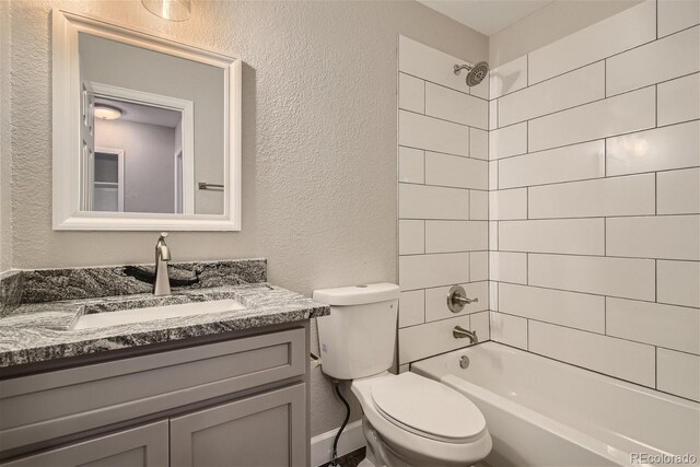 3401 W Milan Ave, Denver, CO 80236 - full bathroom with a textured wall, toilet, vanity, and bathtub / shower combination