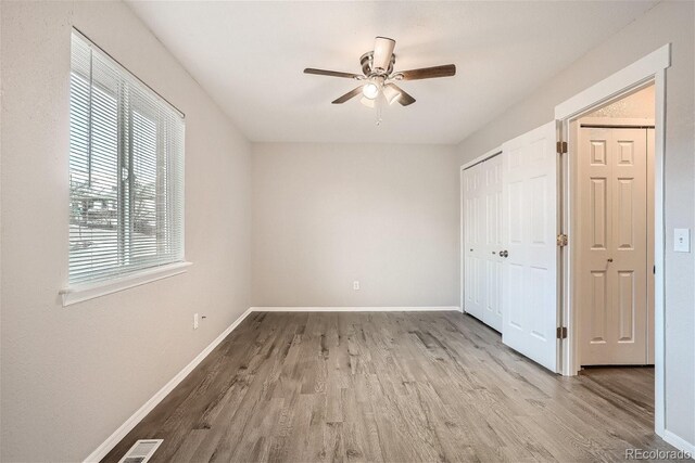 3401 W Milan Ave, Denver, CO 80236 - unfurnished bedroom with wood finished floors, baseboards, and ceiling fan