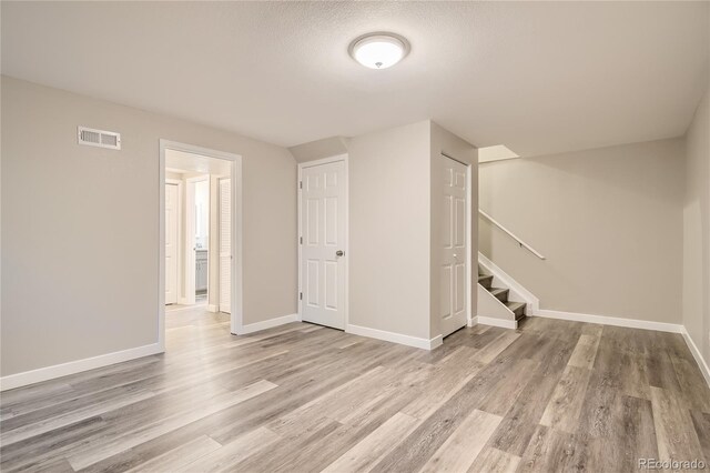 3401 W Milan Ave, Denver, CO 80236 - basement with wood finished floors, stairs, and baseboards